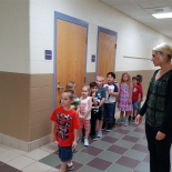 Teacher with students in hallway