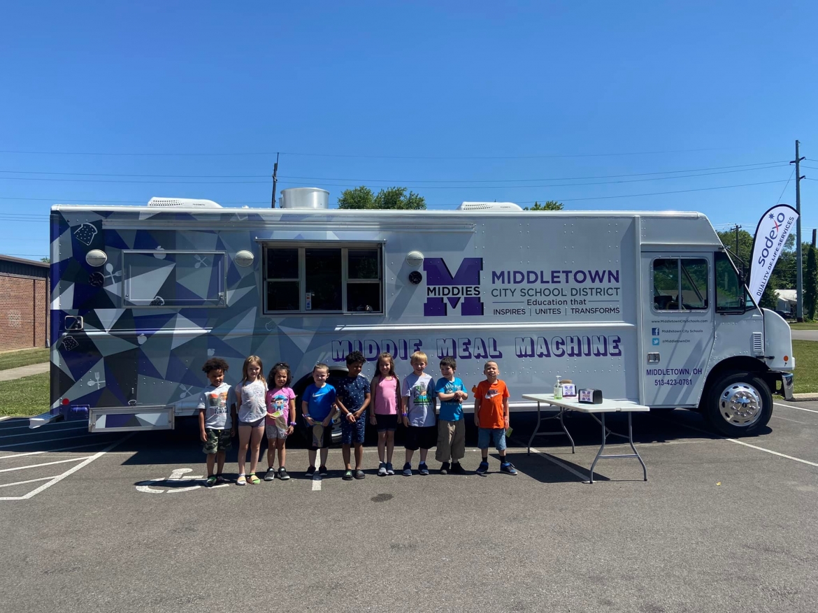 Children in front of the Middie Meal Machine food truck