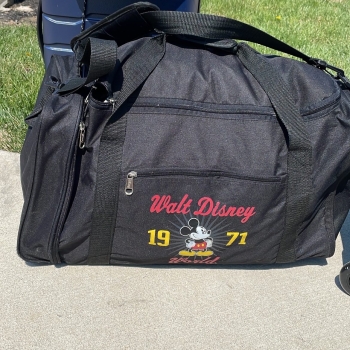 Black duffle bag that says Walt Disney
