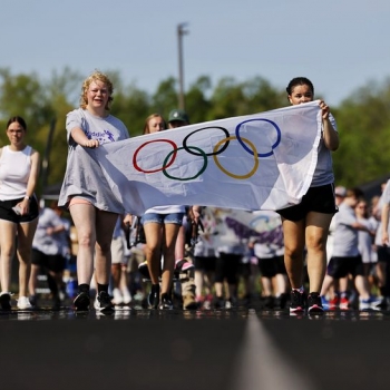 Students carrying the Olympics banner