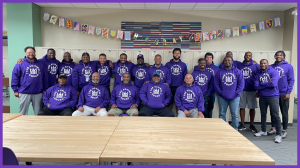 Group of Black men in purple hoodies with the Admiral Squad logo