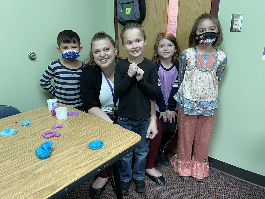 Counselor with four 1st grade students