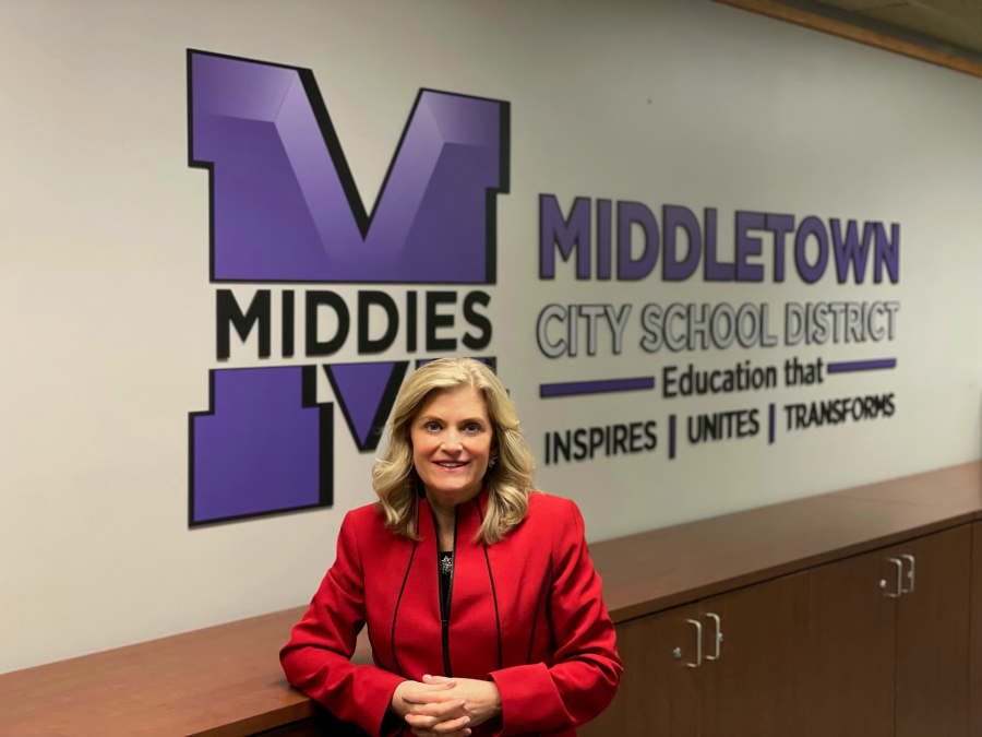 Deb Houser picture in front of MCSD logo